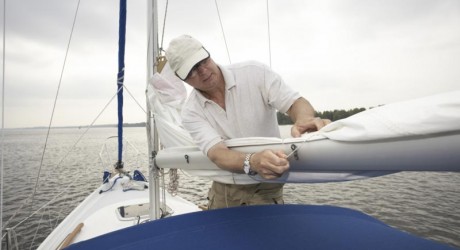 boat preparation for hurricane- man tying down boat